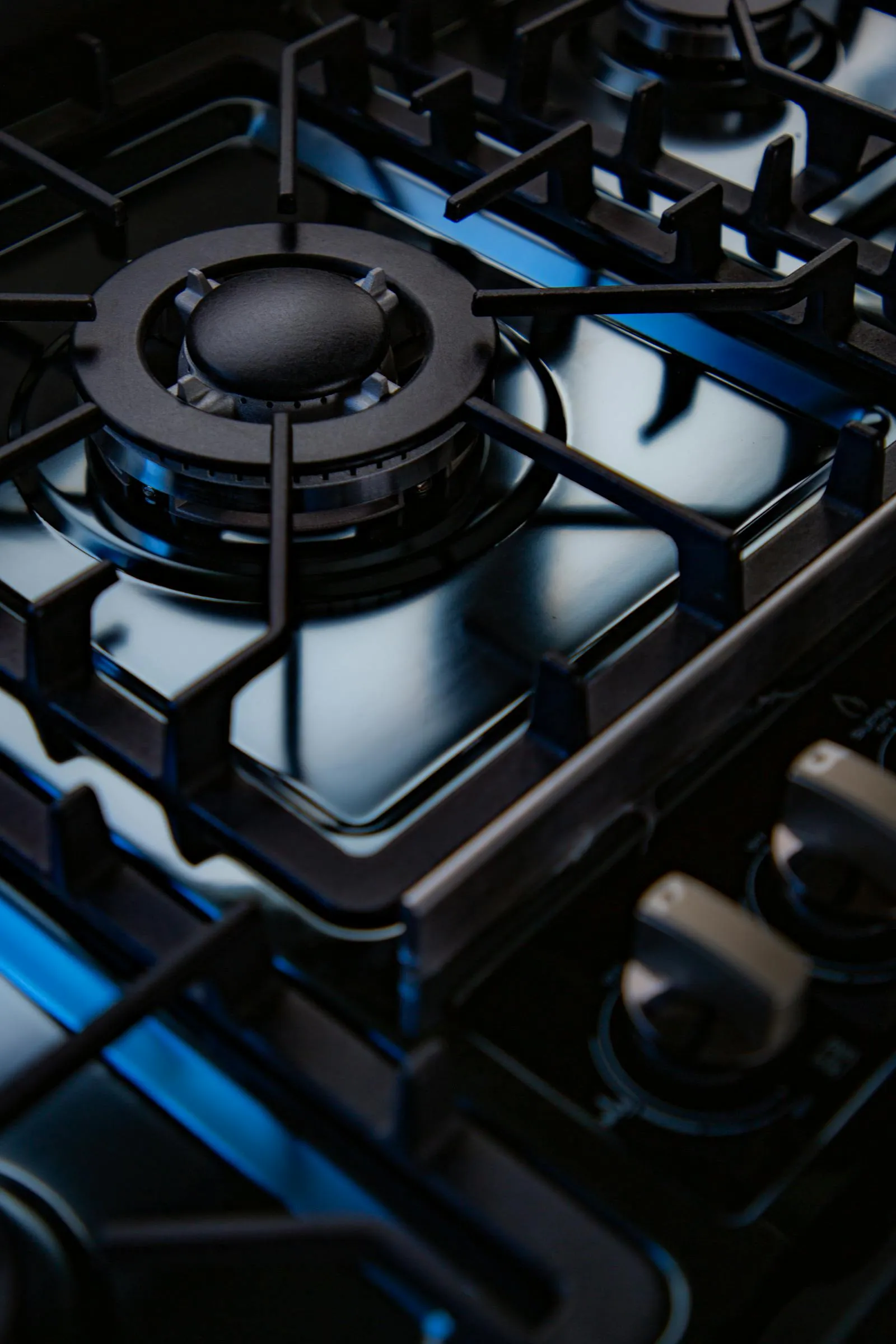 Close-up of a black domestic gas hob with cast-iron pan supports